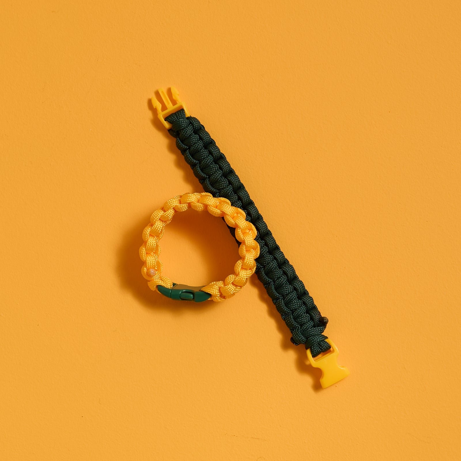 Finished yellow and green bracelets from the ODIDOMI Adventure Bracelet Kit shown flat and buckled.