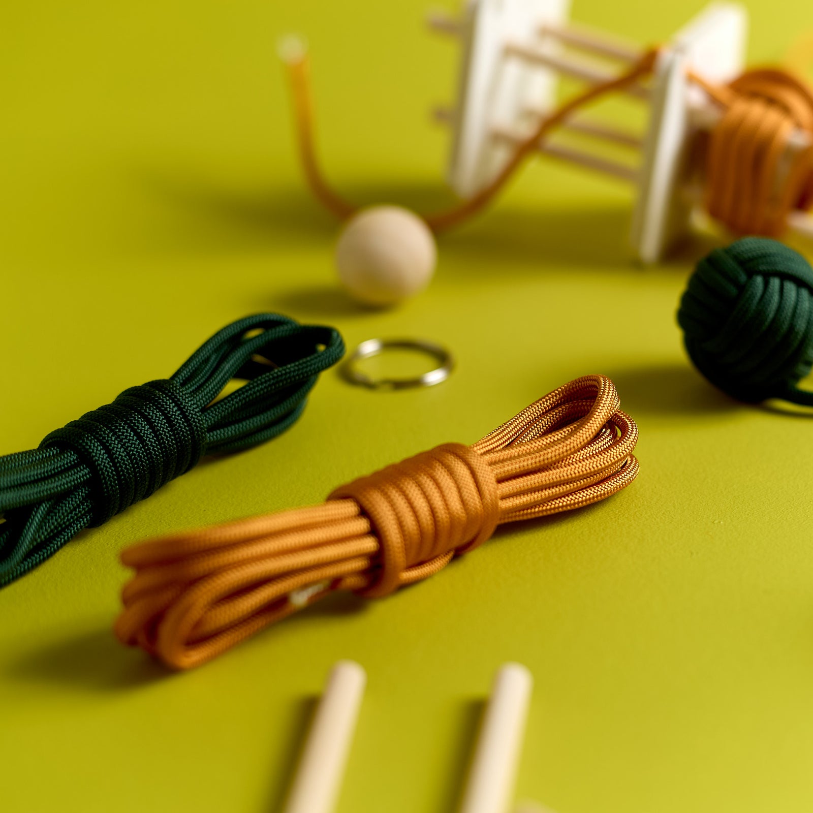 Close-up of parts included in the ODIDOMI Loop & Knot Keychain kit.