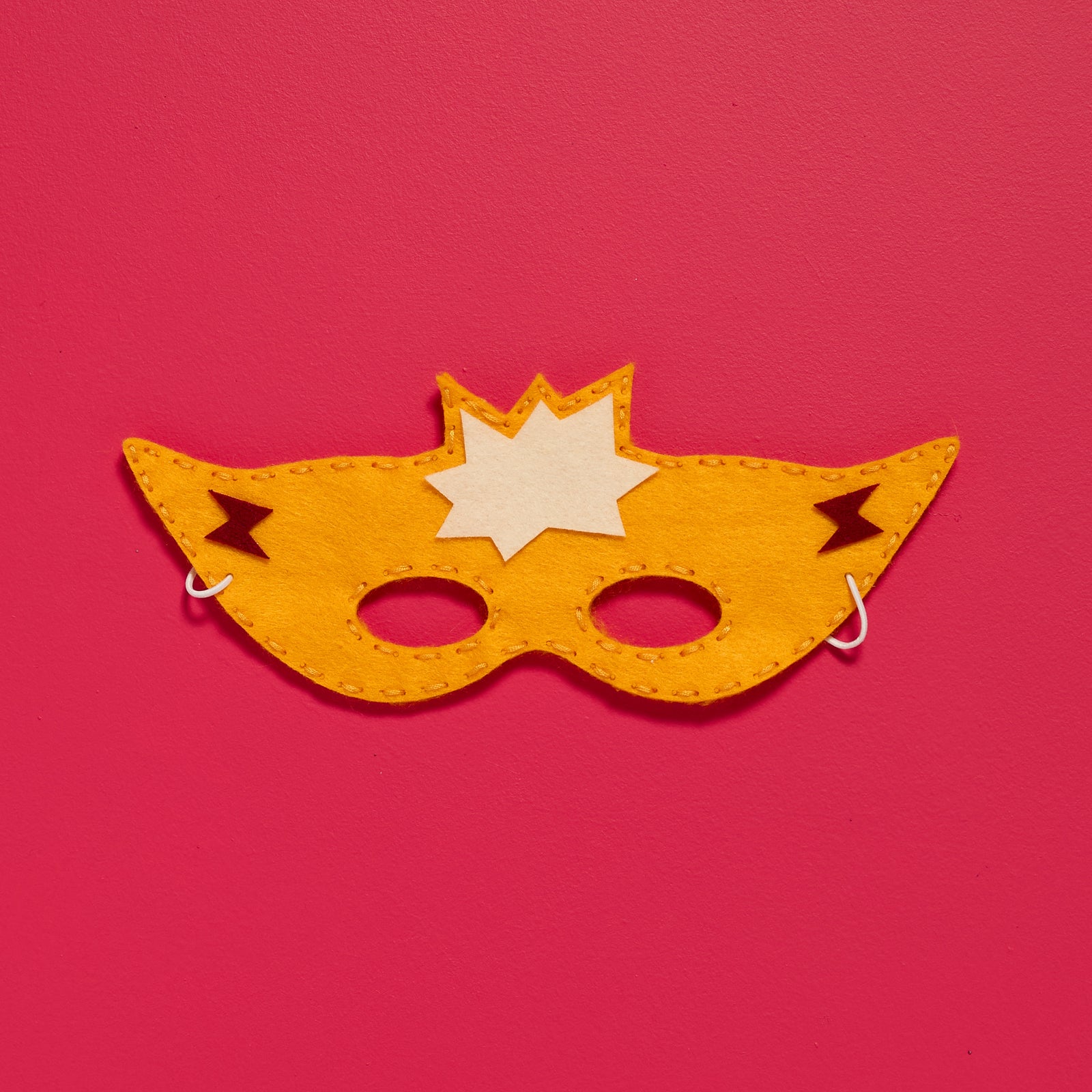 Overhead view of a finished Sew-Your-Own Superhero Mask from an ODIDOMI kids sewing activity kit.