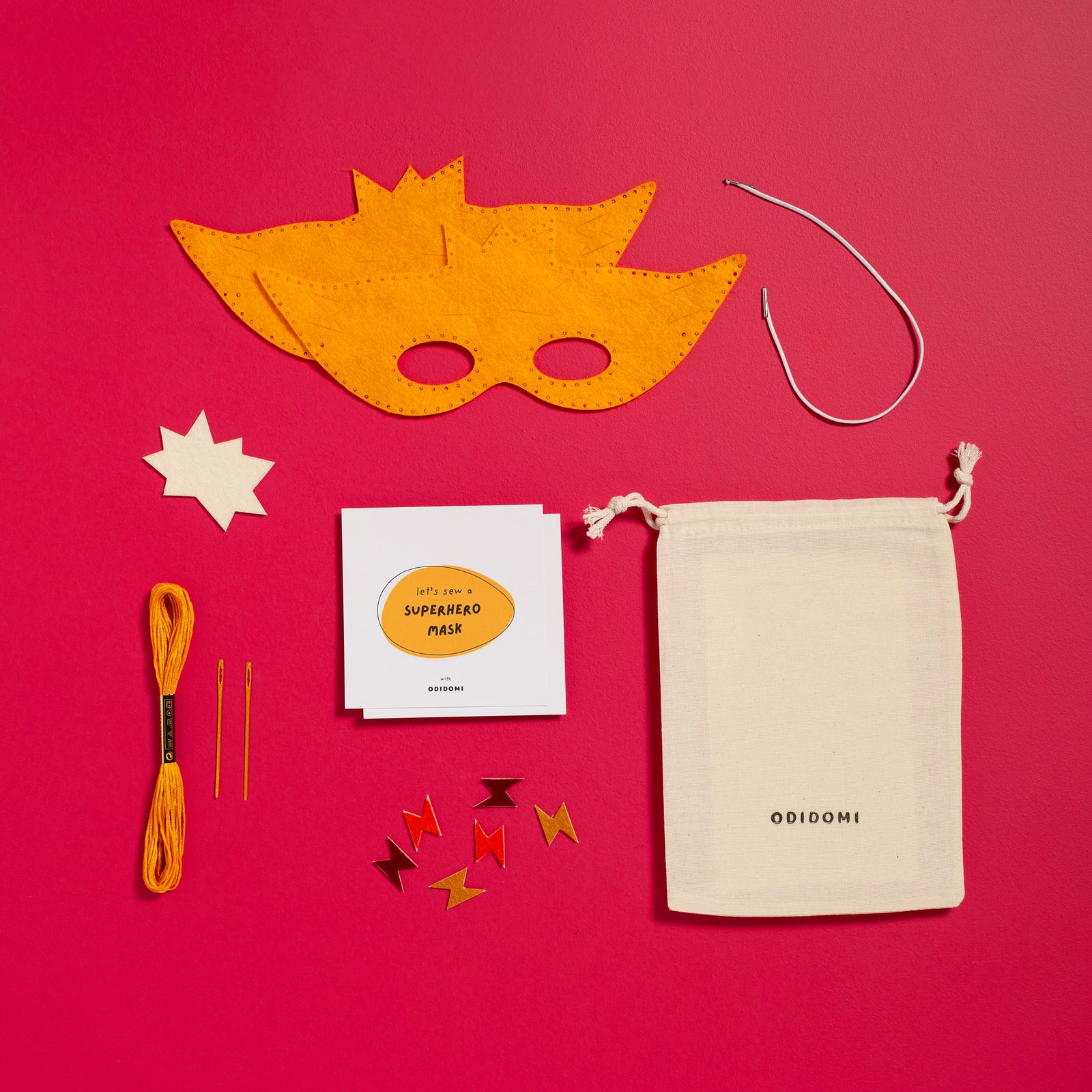 Flat lay of the complete ODIDOMI Sew-Your-Own Superhero Mask kit for kids.