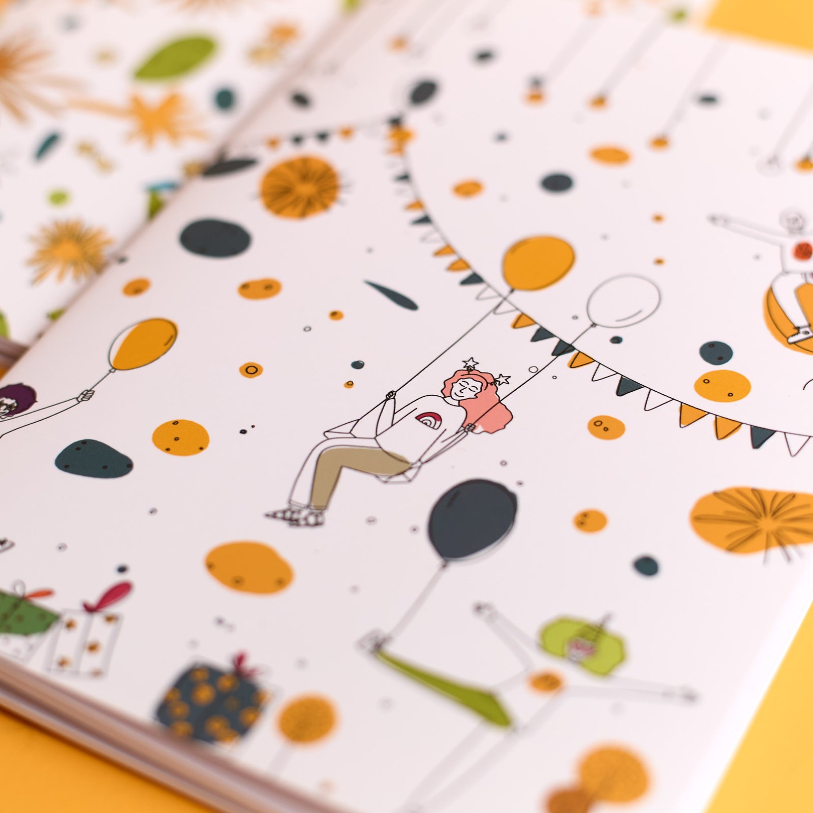 Close-up of the Celebration Scene notebook included in the ODIDOMI stationery kit.