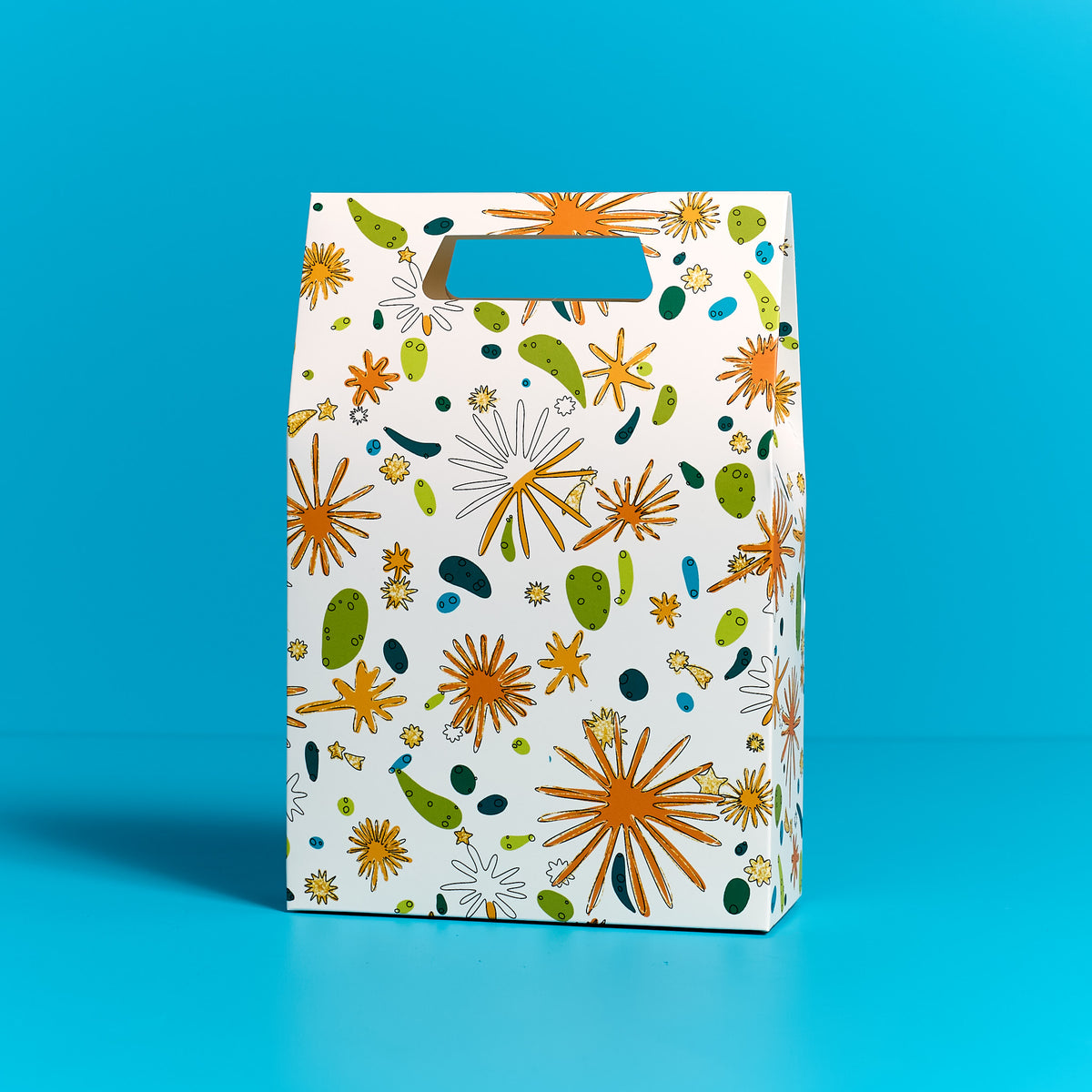ODIDOMI goodie bag featuring a vibrant, nature-inspired design with gold accents, displayed on a blue background. Designed in-house by ODIDOMI, a family-run brand crafting high-quality, handcrafted party favor bags for kids' celebrations.