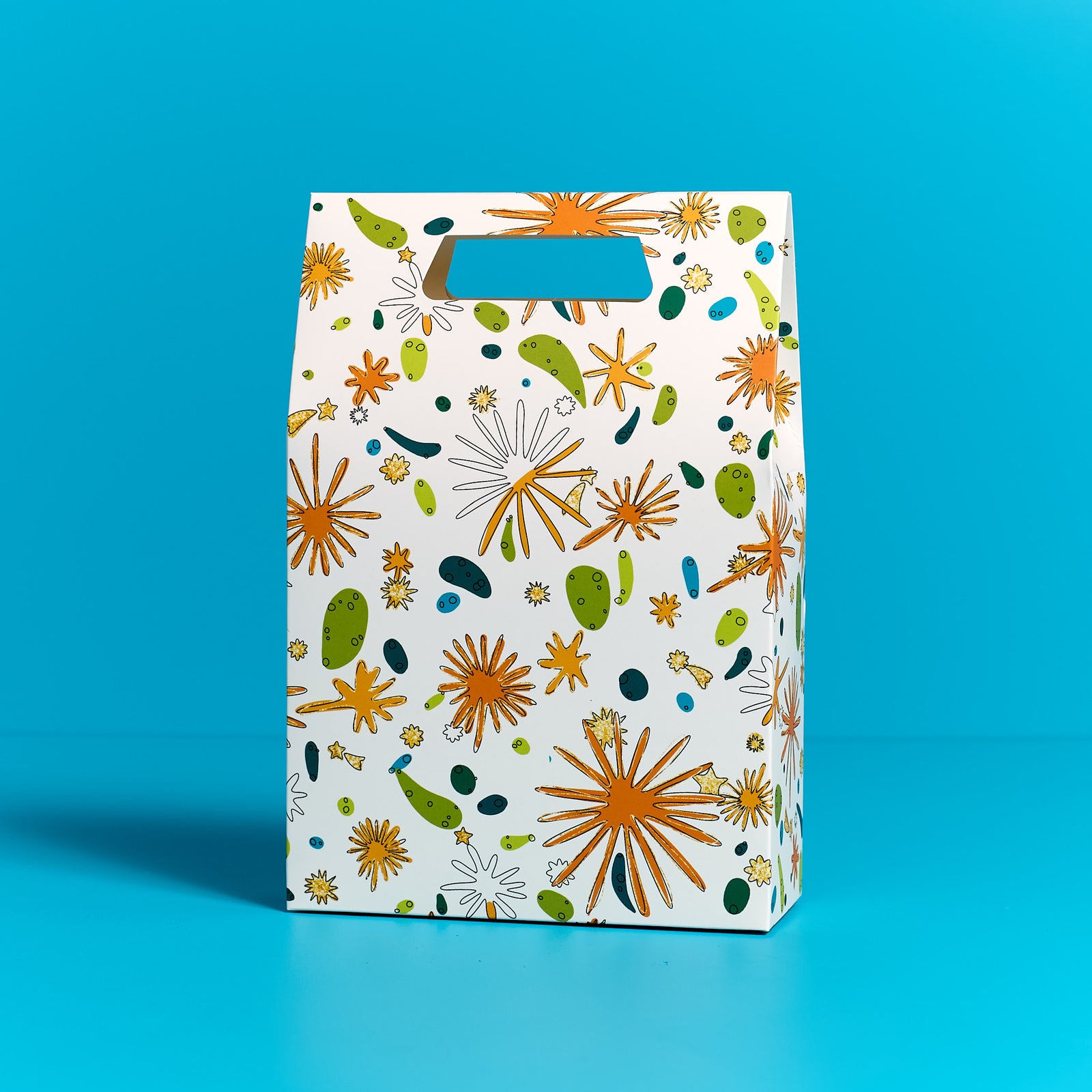 ODIDOMI goodie bag featuring a vibrant, nature-inspired design with gold accents, displayed on a blue background. Designed in-house by ODIDOMI, a family-run brand crafting high-quality, handcrafted party favor bags for kids' celebrations.