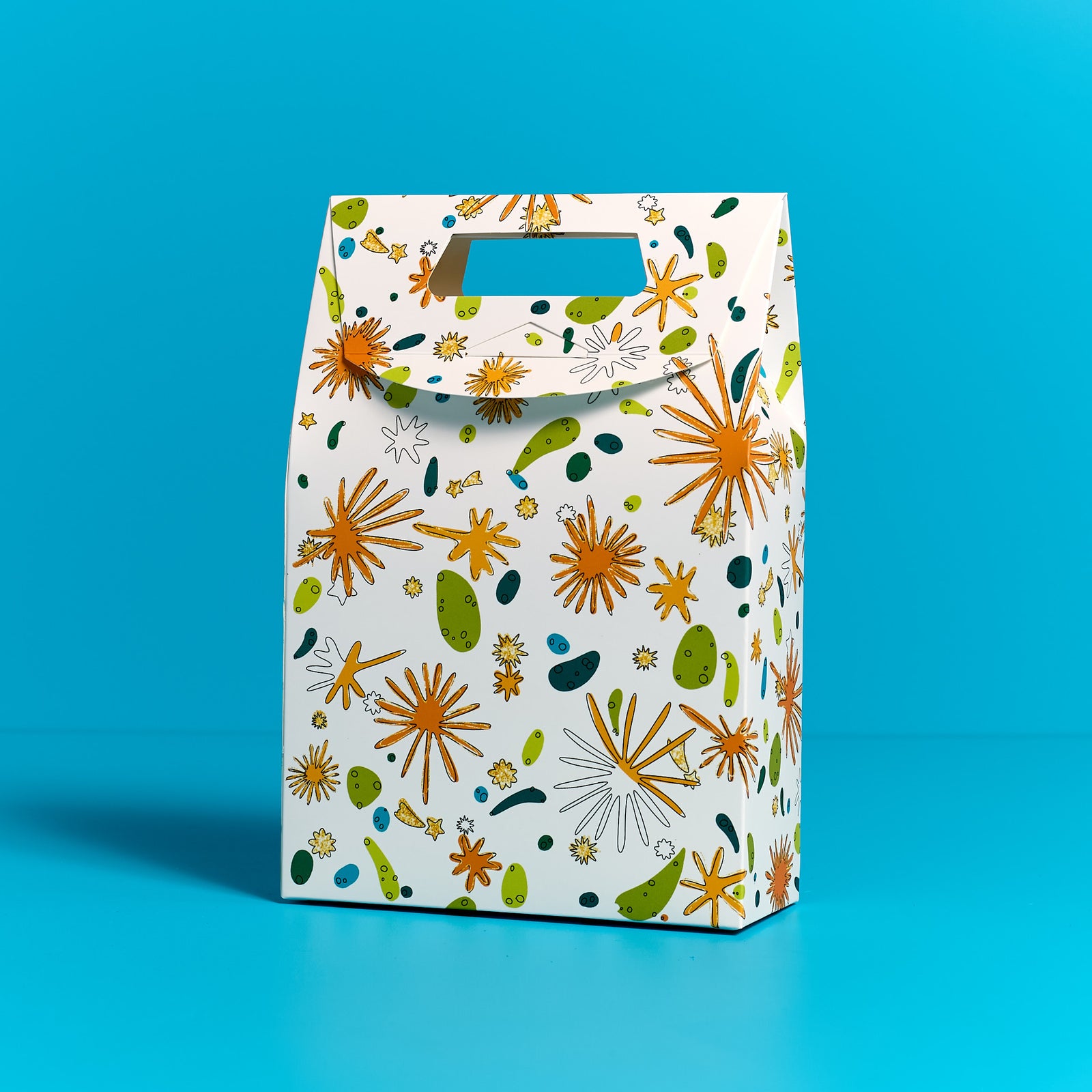 ODIDOMI goodie bag featuring a vibrant, nature-inspired design with gold accents, displayed on a blue background. Designed in-house by ODIDOMI, a family-run brand crafting high-quality, handcrafted party favor bags for kids' celebrations.