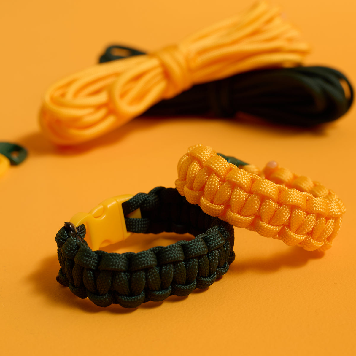 Close-up of finished buckled bracelets from the ODIDOMI Adventure Bracelet Kit in yellow and green.