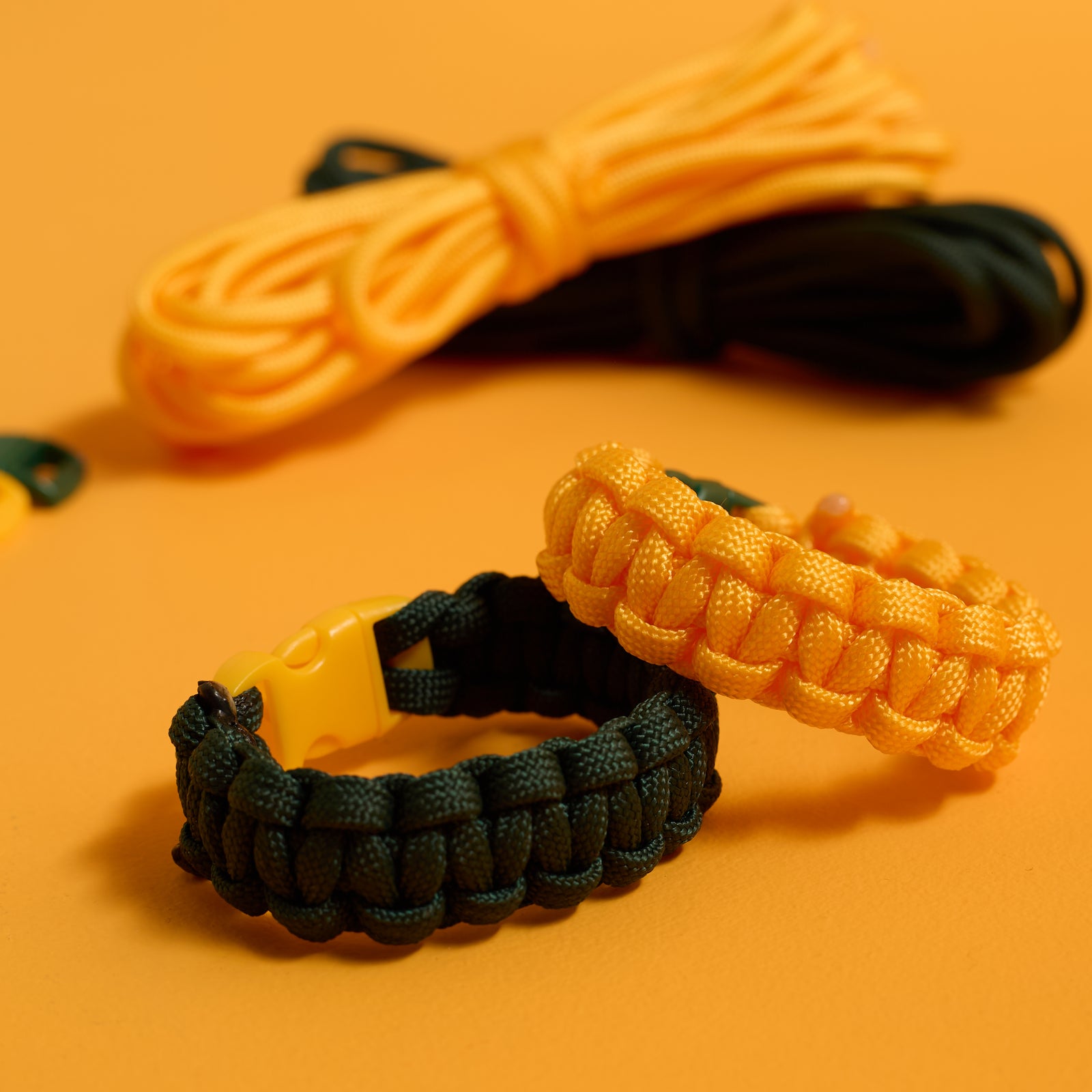 Close-up of finished buckled bracelets from the ODIDOMI Adventure Bracelet Kit in yellow and green.