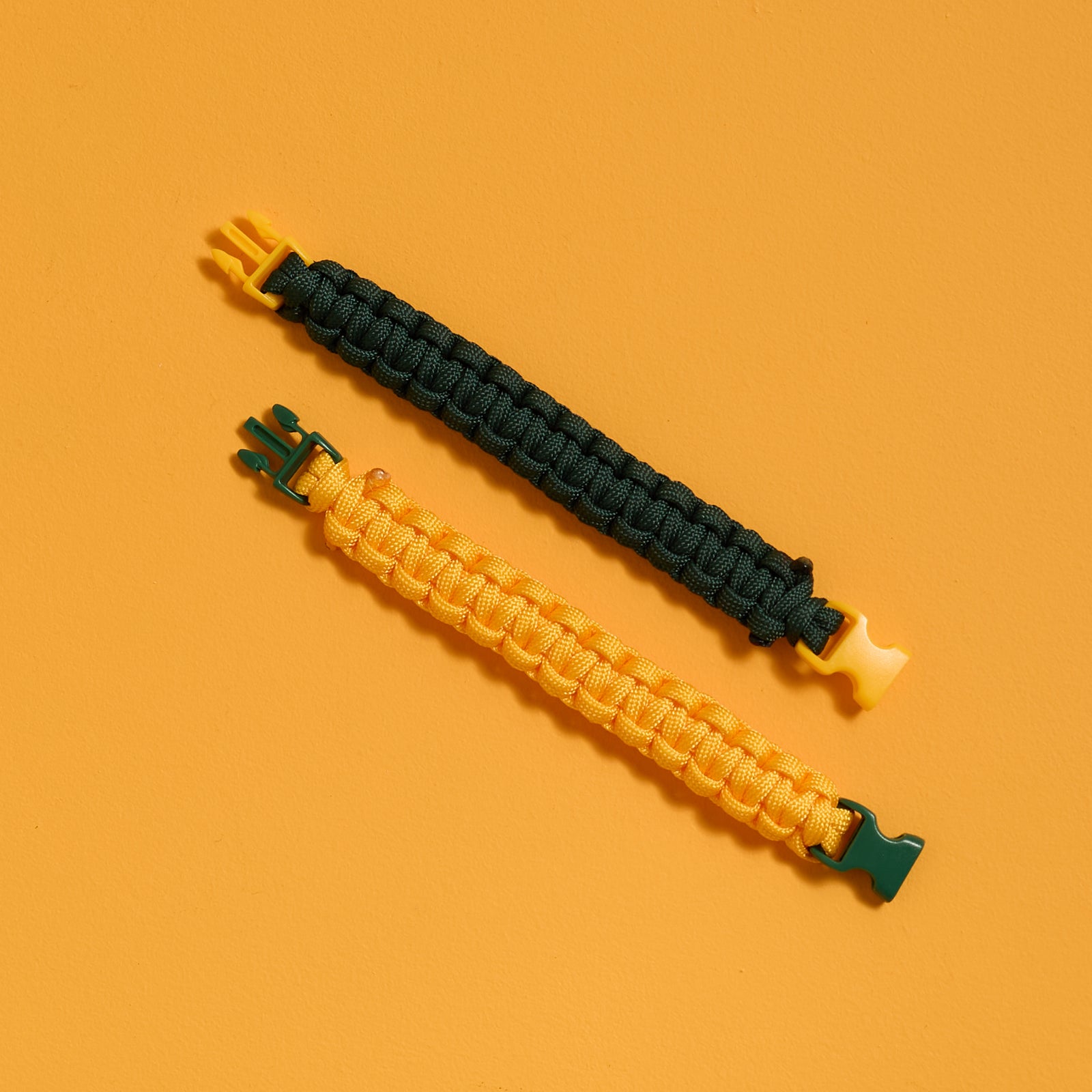 Flat view of finished bracelets from the ODIDOMI Adventure Bracelet Kit in yellow and green.