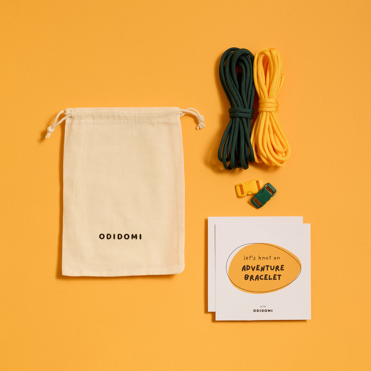 Flat lay of the complete ODIDOMI Adventure Bracelet Kit in the yellow and green color option.