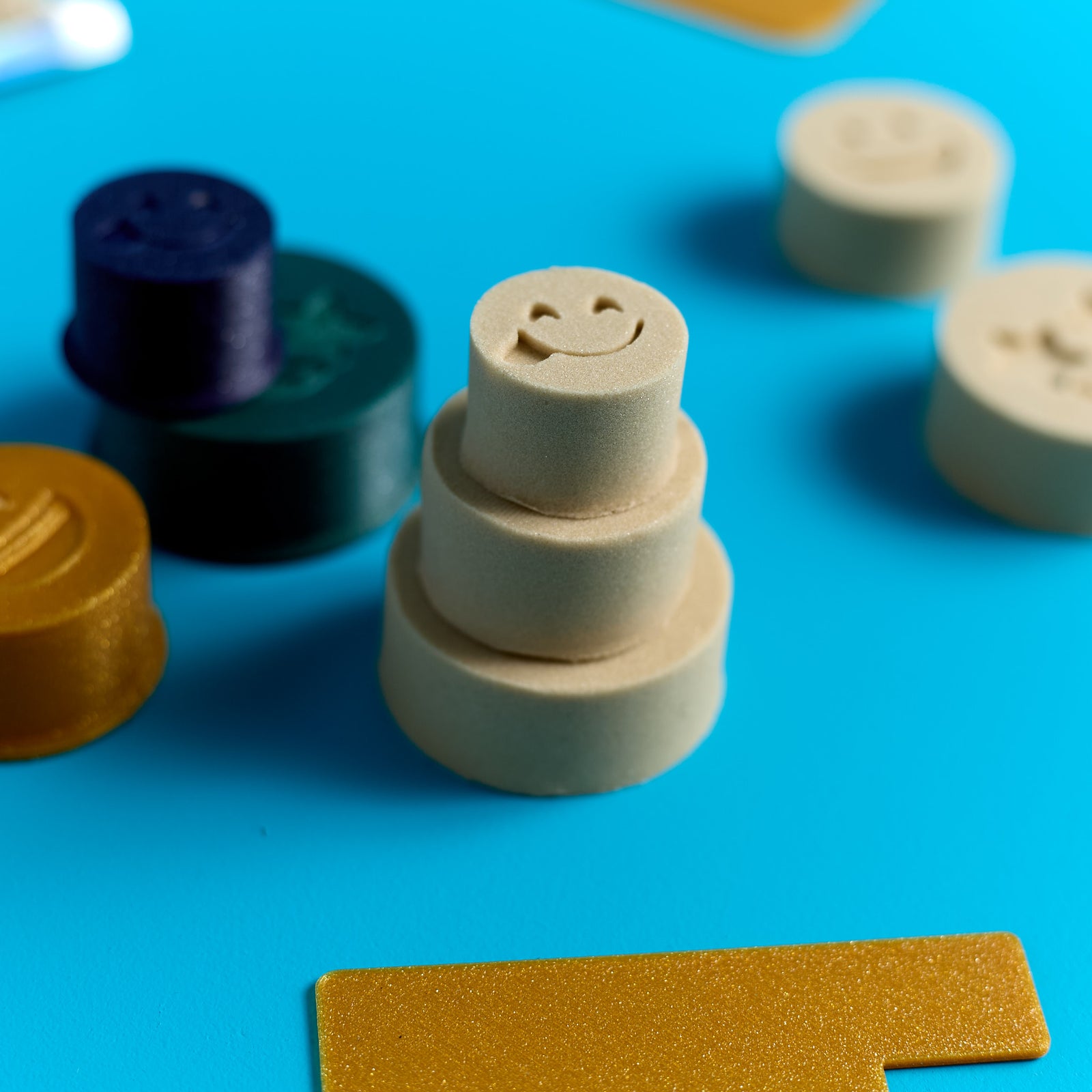 Close-up of stacked Magic Sand cake creations from an ODIDOMI sensory activity kit for kids.