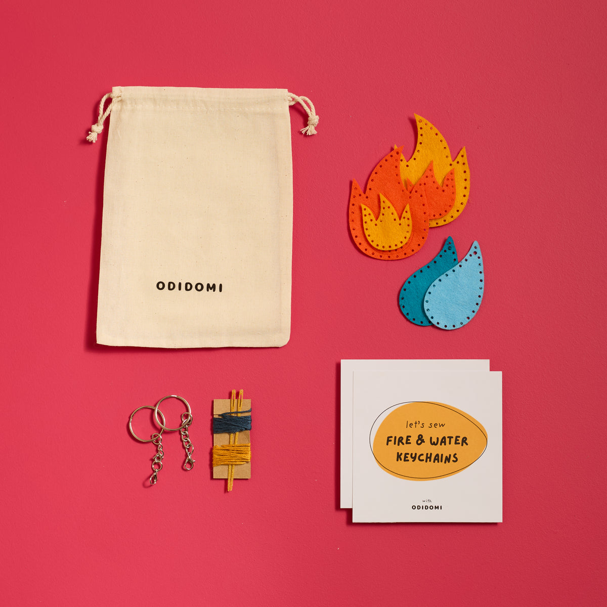 Full Fire & Water Keychains sewing kit for kids by ODIDOMI displayed on a pink background