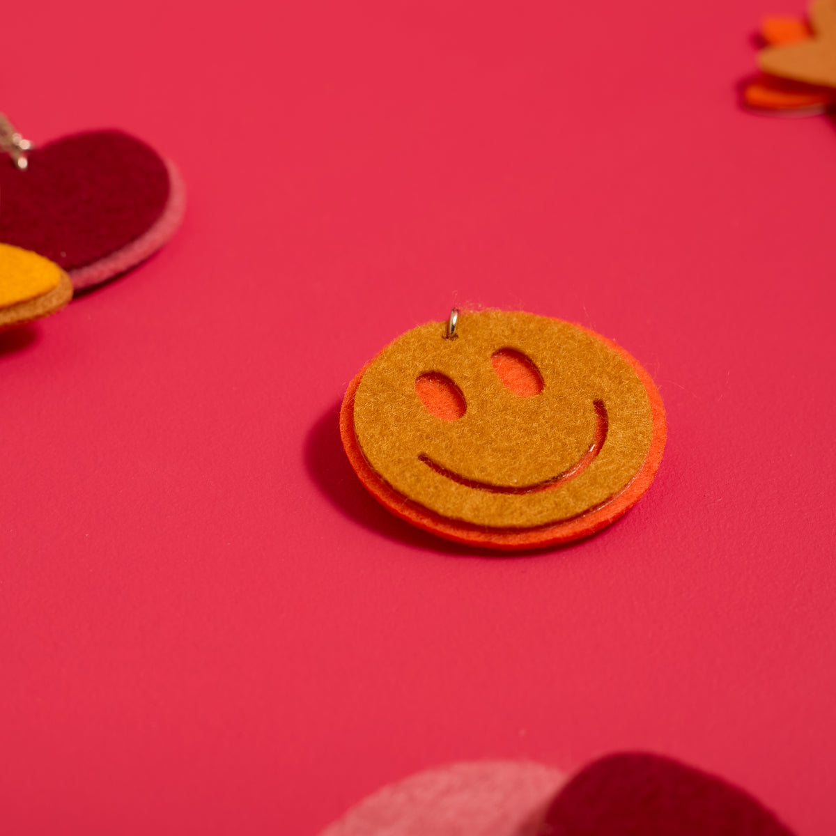 Close-up of a smiley face keychain created with the ODIDOMI Little Joy Keychain Kit.