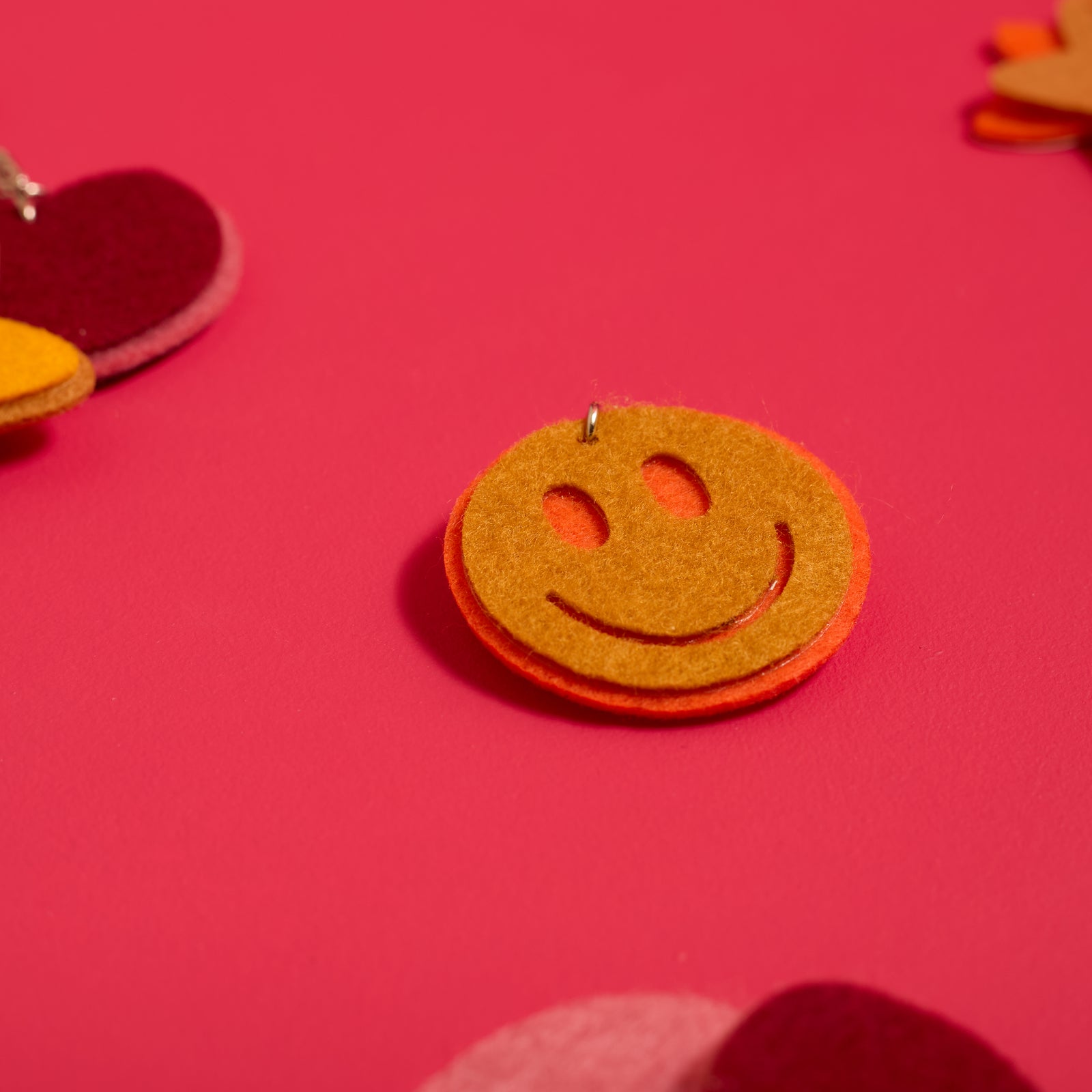 Close-up of a smiley face keychain created with the ODIDOMI Little Joy Keychain Kit.
