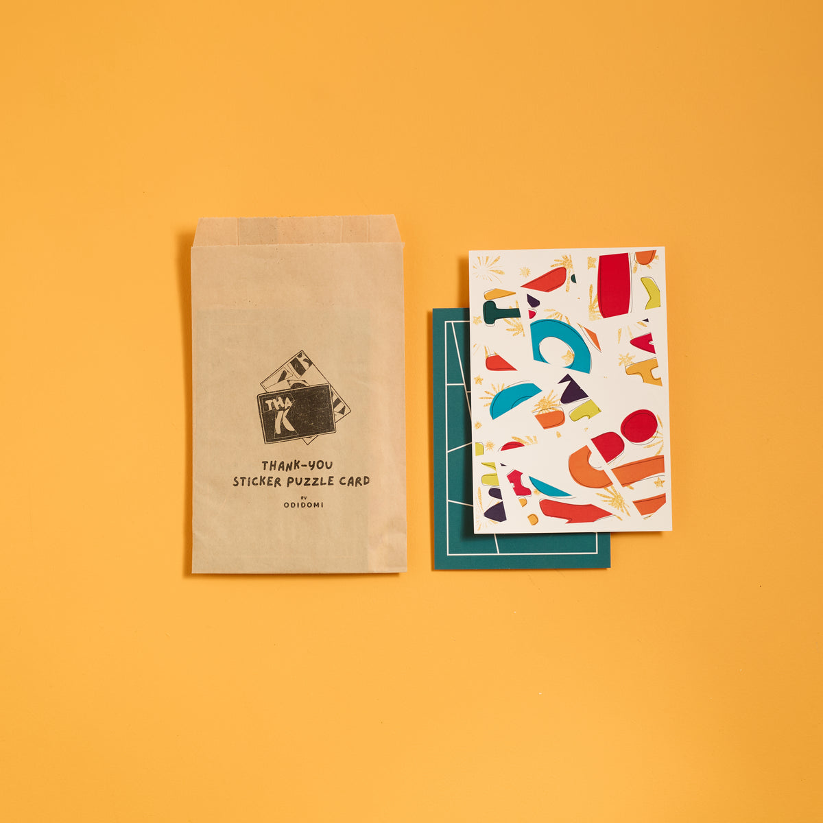 Flat lay of ODIDOMI thank you puzzle card party favor set