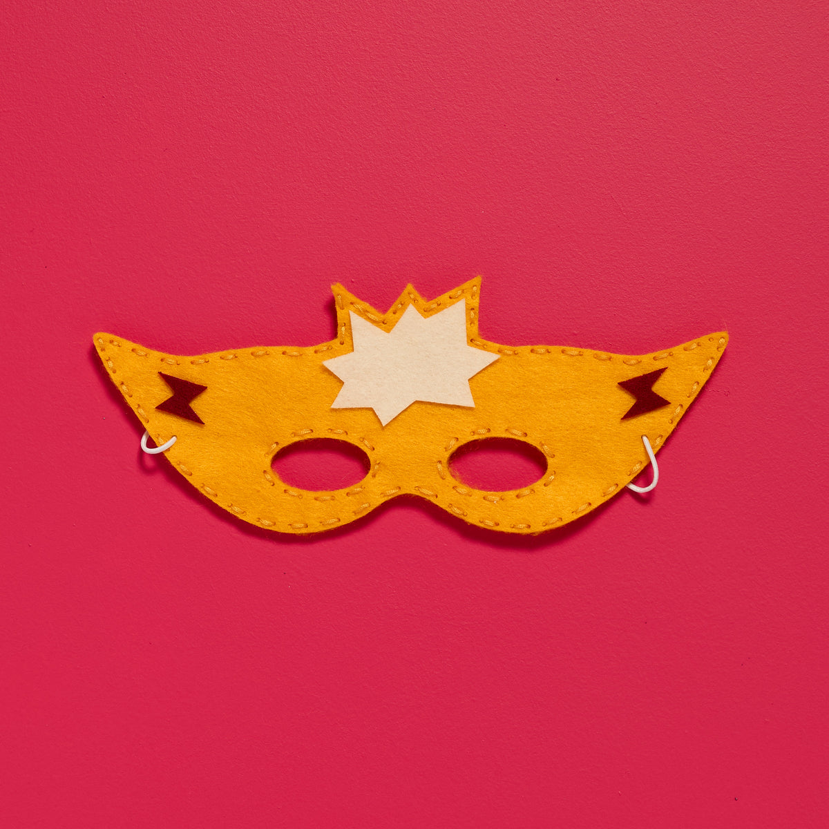 Overhead view of a finished Sew-Your-Own Superhero Mask from an ODIDOMI kids sewing activity kit.