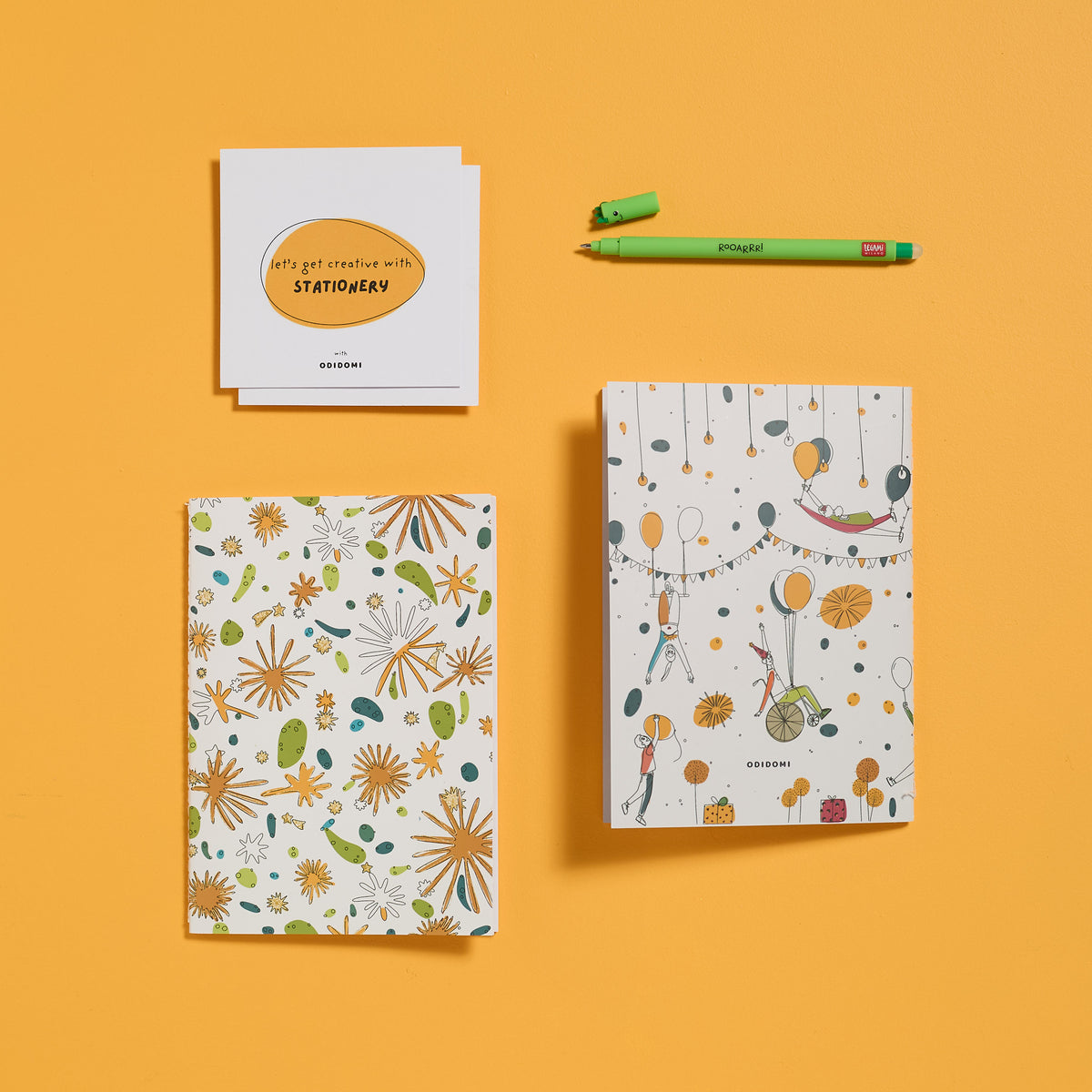 Flat lay of the complete ODIDOMI stationery kit with the Dino Pen option.