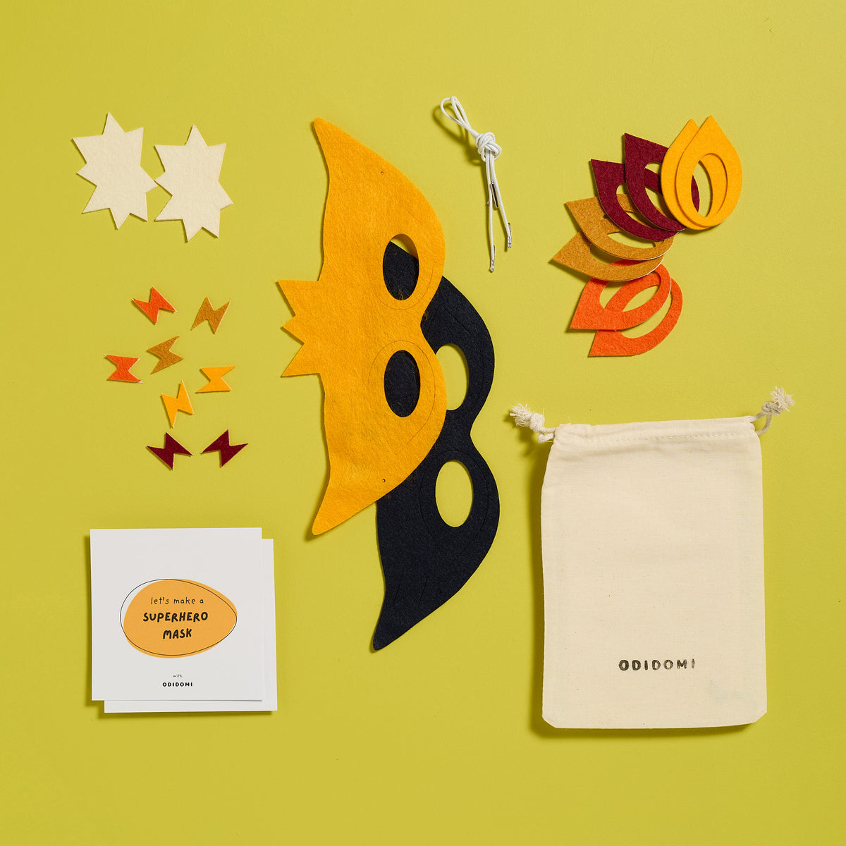 Flat lay of the complete ODIDOMI Stick Superhero Mask kit for kids.