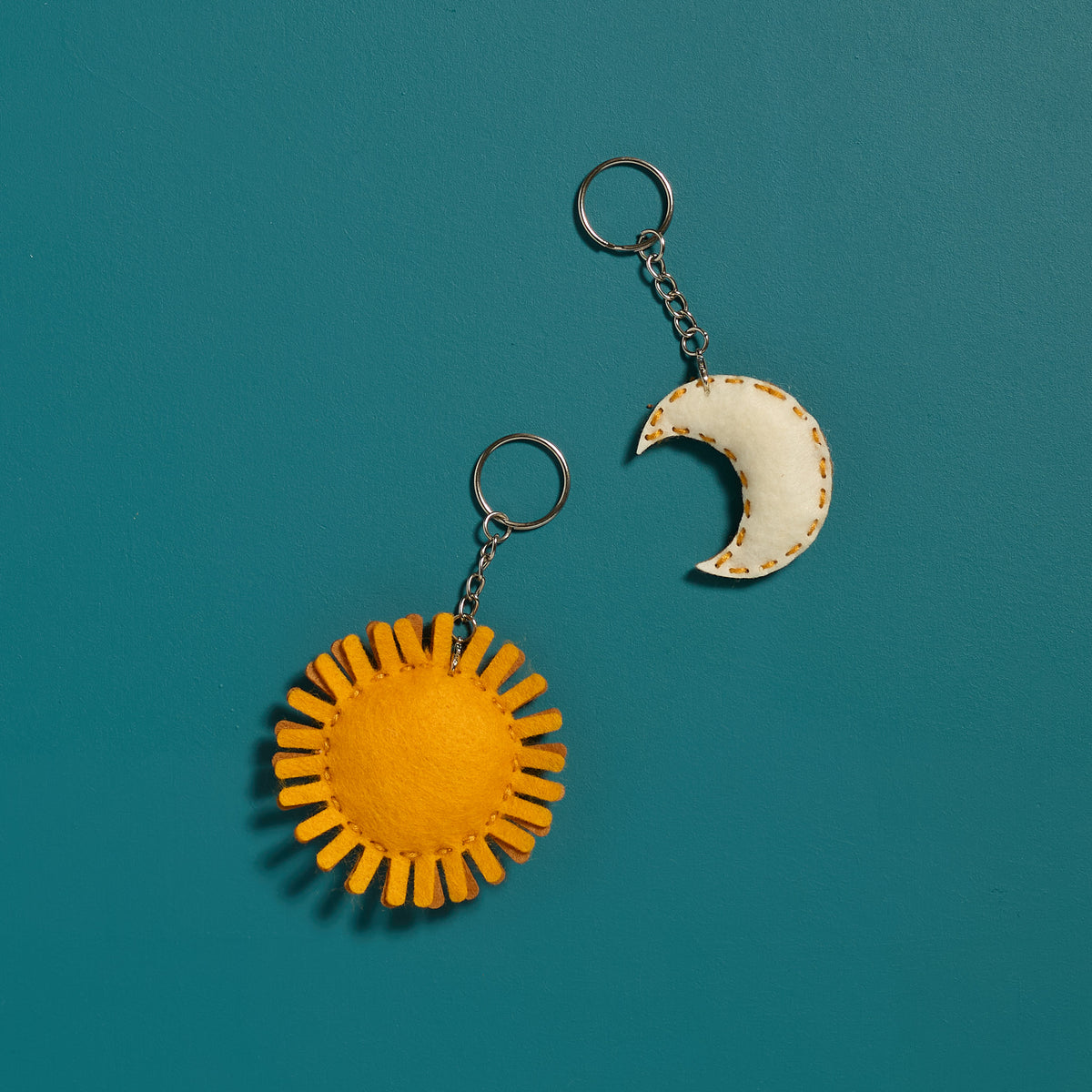 Overhead view of a finished Sun &amp; Moon keychain from an ODIDOMI kids craft activity kit.