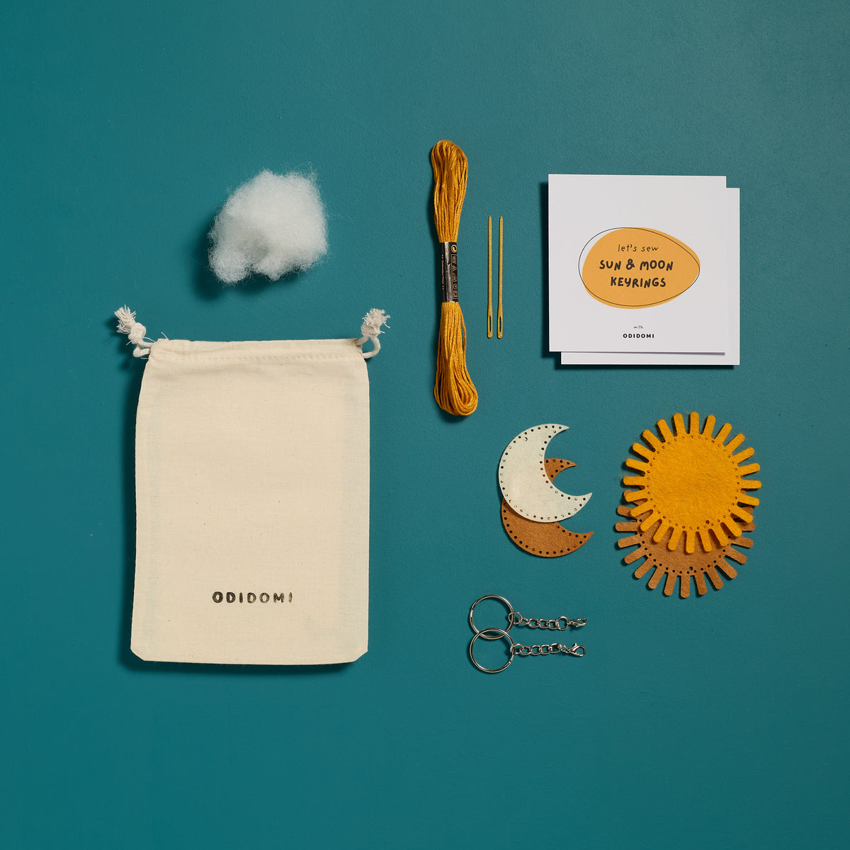 Flat lay of the complete ODIDOMI Sun & Moon keychain kit for kids.