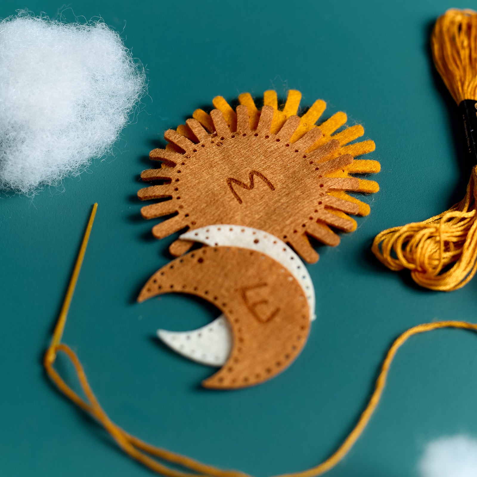 Close-up of personalized felt templates included in the ODIDOMI Sun & Moon keychain kit.